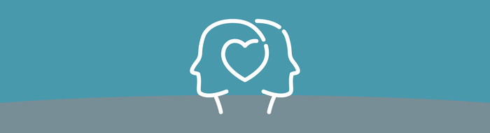 Zwei Köpfe mit Herzsymbol.